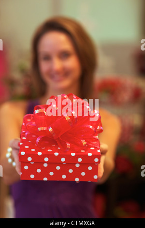 A young woman holding a present, Pietermaritzburg, KwaZulu-Natal, South Africa Stock Photo