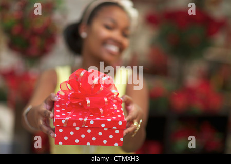 A young woman holding a present, Pietermaritzburg, KwaZulu-Natal, South Africa Stock Photo