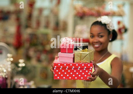 A young woman holding  presents, Pietermaritzburg, KwaZulu-Natal, South Africa Stock Photo