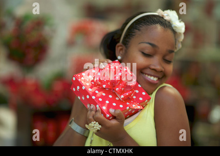 A young woman holding a present, Pietermaritzburg, KwaZulu-Natal, South Africa Stock Photo