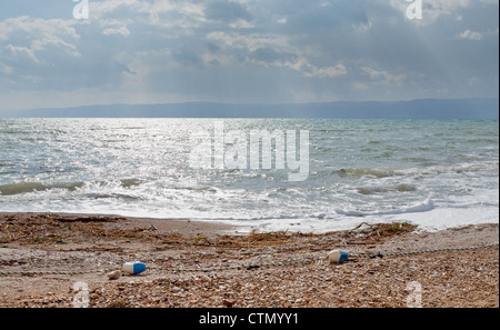 pebble beach of Dead sea in Jordan on sunset Stock Photo