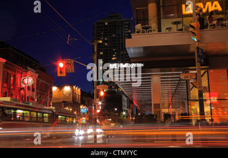 Night life on King Street East in Toronto including Tiff Bell Lightbox Festival Tower and trendy restaurants Stock Photo