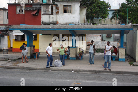 Locals waiting at a bus stop in a Cuban Village in the Suburds of Havana Stock Photo