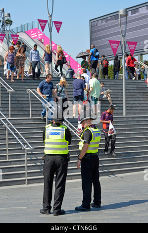 Police officers on duty at entrance steps to the 2012 Olympic Park and the Westfield Stratford City shopping centre Stock Photo