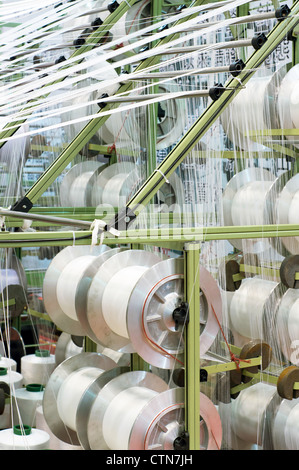 Group of bobbin thread cones on a warping machine in a textile mill ...