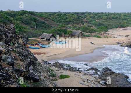 Fishing shacks and outrigger boats on beach, Bundala National Park, Sri Lanka Stock Photo