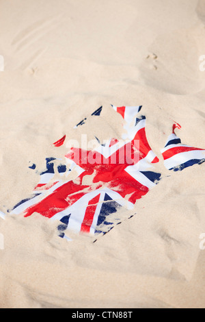 Union Jack flag covered in sand on the beach Stock Photo