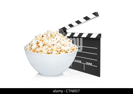 A studio shot of an open movie clap and bowl full of popcorn isolated on white background Stock Photo