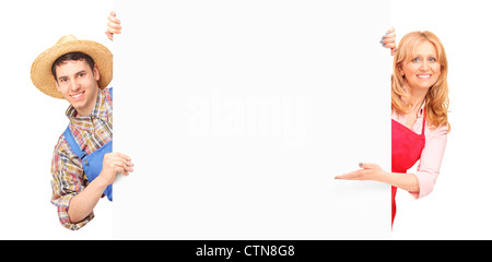 Male and female gardeners holding a white panel, isolated on white background Stock Photo