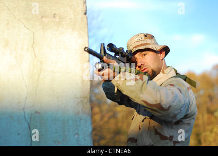 Soldier in camouflage aiming with his rifle outdoor Stock Photo - Alamy