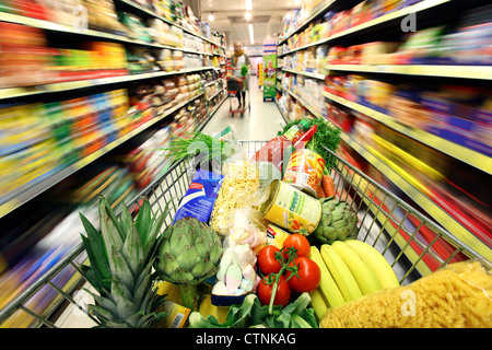 Food hall, full shopping trolley is pushed through a hallway with Stock ...