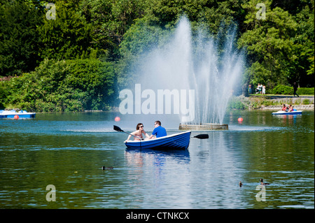 People enjoy boating on hot summer day, Victoria Park, Hackney, London, United Kingdom Stock Photo