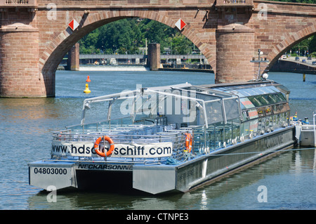 Heidelberg Germany - Solar catamaran Neckarsonne in front of the historical Old Bridge over the River Neckar and the ship lock Stock Photo