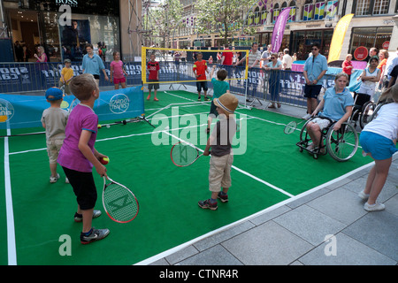 Children play tennis and badminton at Cardiff City Council ON YOUR MARKS sporting events in the city centre London Olympics 2012  KATHY DEWITT Stock Photo
