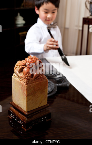 Young boy practising Chinese calligraphy Stock Photo