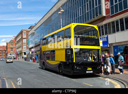 Blackpool Bus stops to pick up passengers in the town centre Stock Photo