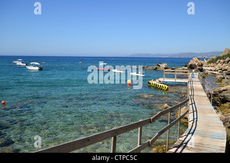 A wooden jetty on Pefkos beach on the Greek Island of Rhodes Stock Photo