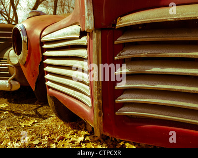 Fine art image of an old rusty vintage car in a junk yard. Stock Photo