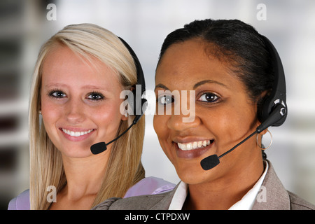 Young women giving help as customer service employees Stock Photo