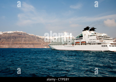 Cruise ships below Fira the Capital town on the island of Santorini in the Cyclades islands in Greece Stock Photo