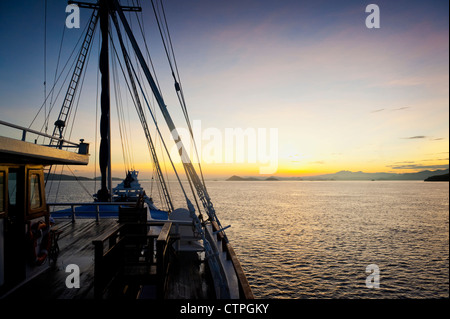 Sunrise aboard the 108 foot 'Ombak Putih', a traditional Phinisi schooner cruising in the East Nusa Tenggara area of Indonesia. Stock Photo