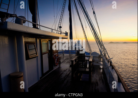 Sunrise aboard the 108 foot 'Ombak Putih', a traditional Phinisi schooner cruising in the East Nusa Tenggara area of Indonesia. Stock Photo