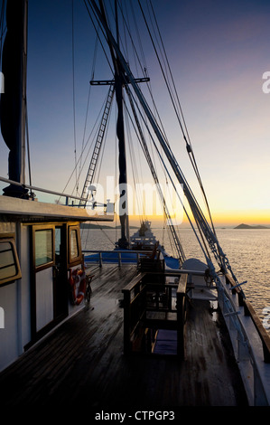 Sunrise aboard the 108 foot 'Ombak Putih', a traditional Phinisi schooner cruising in the East Nusa Tenggara area of Indonesia. Stock Photo