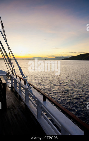 Sunrise aboard the 108 foot 'Ombak Putih', a traditional Phinisi schooner cruising in the East Nusa Tenggara area of Indonesia. Stock Photo