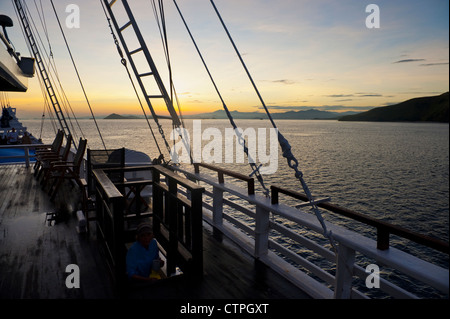 Sunrise aboard the 108 foot 'Ombak Putih', a traditional Phinisi schooner cruising in the East Nusa Tenggara area of Indonesia. Stock Photo