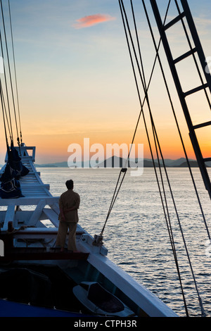 Sunrise aboard the 108 foot 'Ombak Putih', a traditional Phinisi schooner cruising in the East Nusa Tenggara area of Indonesia. Stock Photo