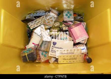 discarded tablets and drugs in a yellow container for disposal confiscated from mail post system