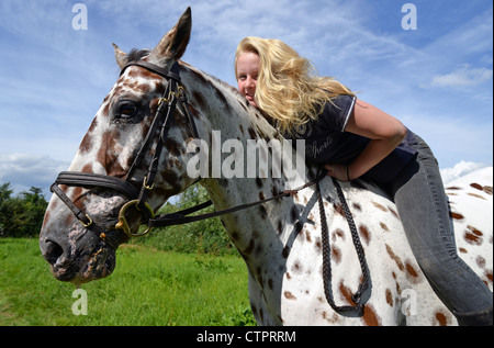 Teenage girl riding appaloosa horse, Stanwell Moor, Surrey, England, United Kingdom Stock Photo