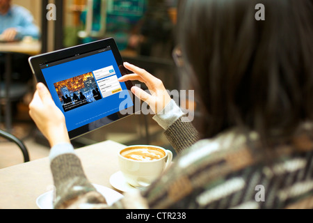 Close up view of female handholding an ipad creating a Twitter account Stock Photo