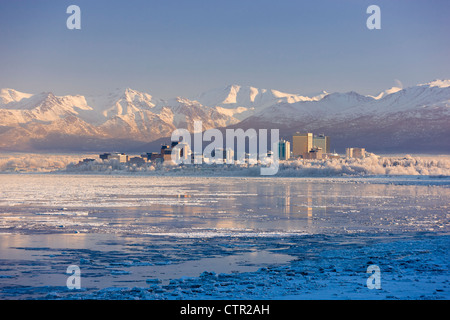Hoarfrost covers trees along Anchorage skyline icy Cook Inlet in foreground on cold mid winter day Southcentral Alaska Stock Photo
