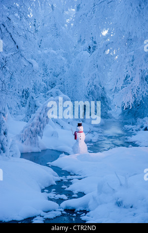 Snowman standing next stream fog hoar frosted trees in background Russian Jack Springs Park Anchorage Southcentral Alaska Stock Photo