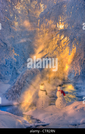 Snowman couple standing next stream sunrays shining through fog hoar frosted trees in background Russian Jack Springs Park Stock Photo