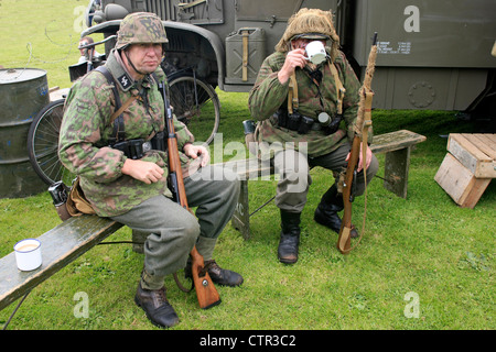 Actor dressed as a Waffen-SS soldiers have a good old British cup of tea at a WW2 weekend Stock Photo