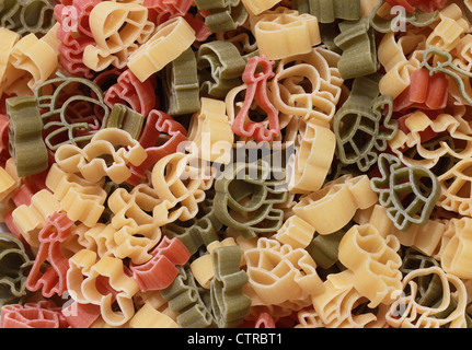 Italian pasta of durum wheat semolina with tomato and spinach in form of various zoo animals. Funny for children. Stock Photo