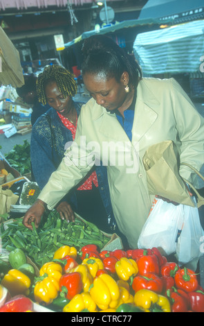 Woman shopping for vegetables at Brixton market, south London, UK. Stock Photo