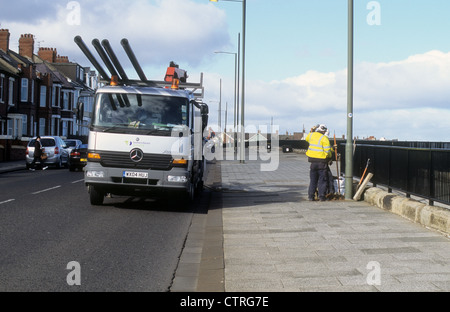 Southern Electric...Co,  Mercedes Benz-Ateco flatbed truck replacing lamp posts upon a roadway in Northern England. Stock Photo