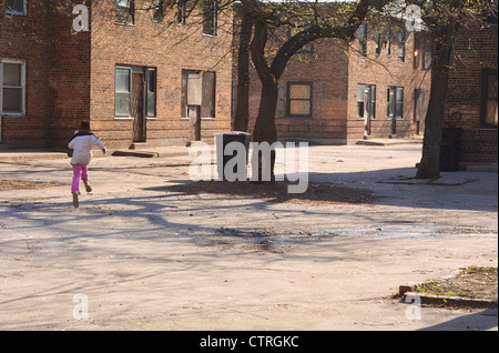 A young girl runs through the condemned Ida B. Wells housing project in Chicago on Apr. 24, 2002.