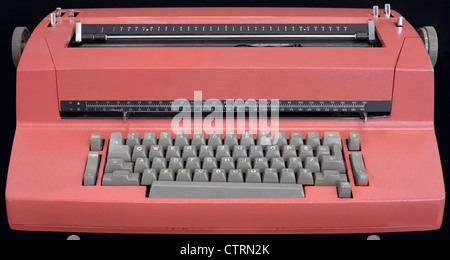 Old Electric Typewriter Isolated on black Background Stock Photo