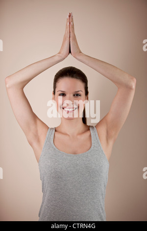A young woman practicing yoga, tree pose Stock Photo