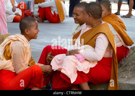 Young Buddhist nuns socialize in (Rangoon) Yangon, (Burma) Myanmar. Stock Photo