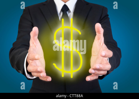Businessman holding graphic dollar sign Stock Photo