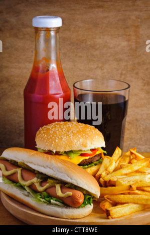 Fast food with burger, hot dog, french fries, tomato ketchup and cola Stock Photo