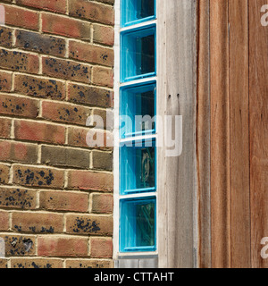 Blue glass bricks within an exterior wall. Stock Photo