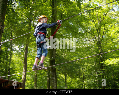 Little girl eight years old climbing in adventure park in Vianden, Luxemburg Stock Photo