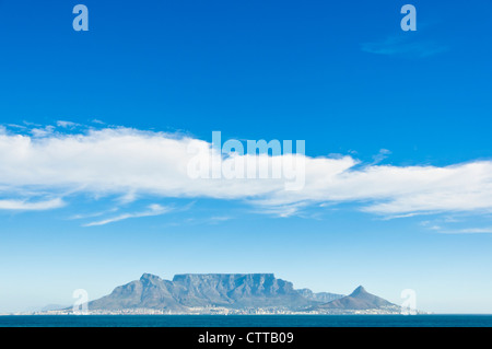 A sunny scenic shot of table mountain as seen from bloubergstrand, with a few scattered clouds Stock Photo
