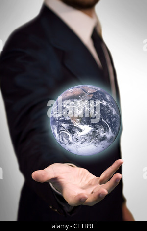 Earth Sphere in the palm of a business man like a magic sphere Stock Photo
